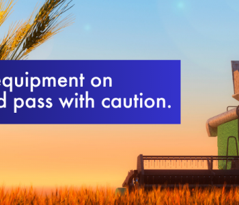 Image of farmer combining in a field, give large harvest equipment space and pass with caution
