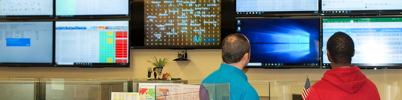 NDIT employees monitor several data screens. 