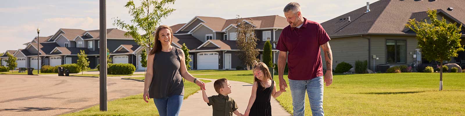 Family walks together on a beautiful summer day in a Bismarck residential neighborhood.