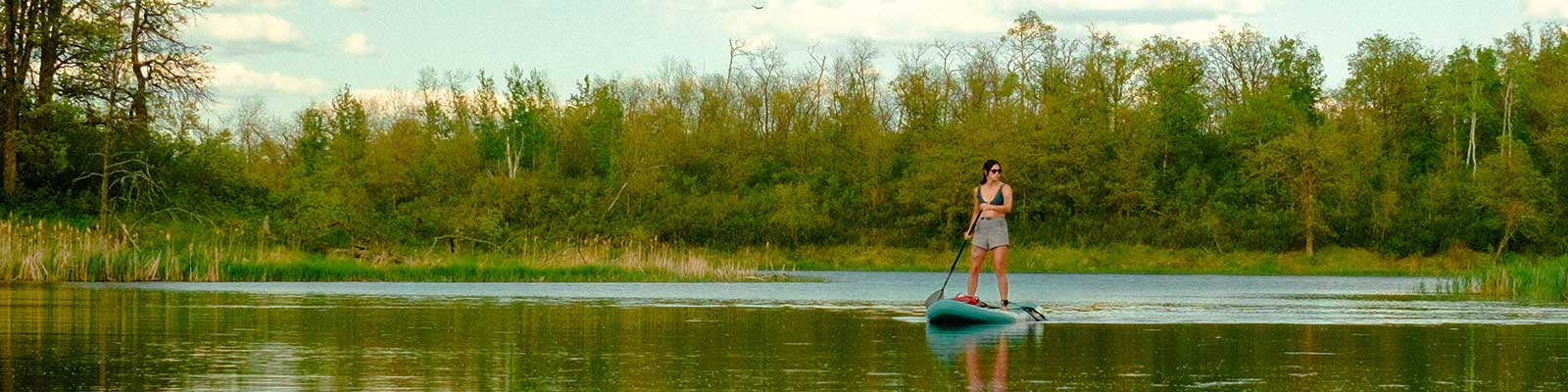 A woman paddleboards at Lake Metigoshe.
