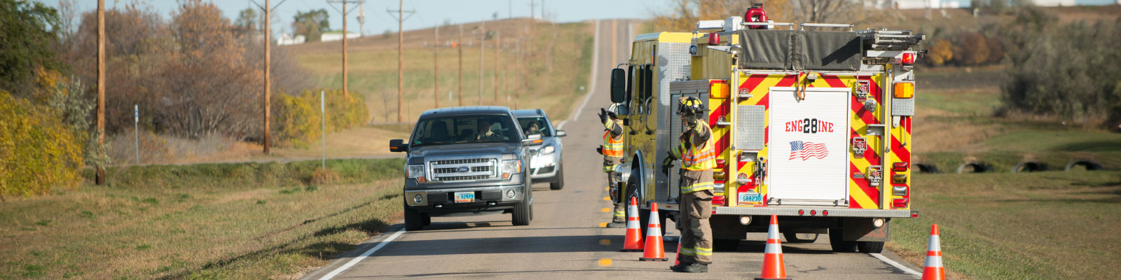 Safety cones reroute traffic around a fire engine. 