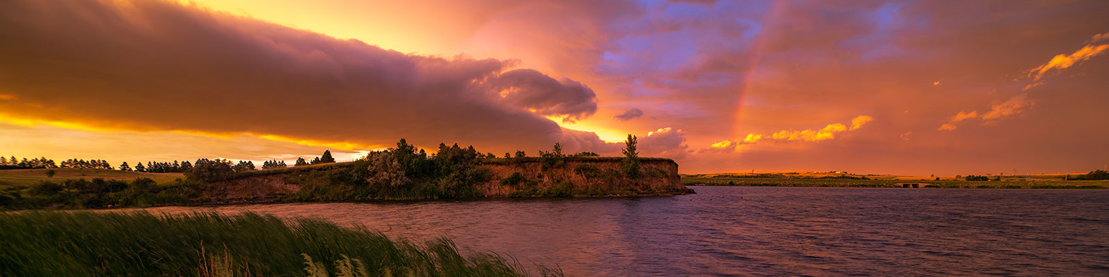 The sun sets behind an exiting storm at Sweet Briar Lake. 